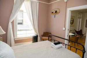 a bedroom with a bed and a large window at Object Hotel 2BR Room 2G in Bisbee