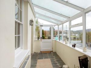 a glass conservatory with a door and windows at 3 Bed in Ambleside oc-62587 in Far Sawrey