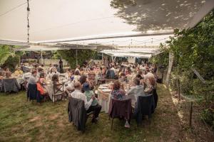 a group of people sitting at tables under a tent at Tumuñan Lodge in El Llano