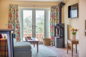 a living room with a fireplace and a sliding glass door at 1 Bed in Pershore oc-t29051 in Pershore