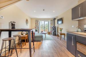 a kitchen and living room with a couch and a table at 1 Bed in Pershore oc-t29051 in Pershore