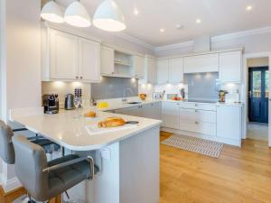 a kitchen with white cabinets and a large island at 3 Bed in Hythe oc-87167 in Hythe