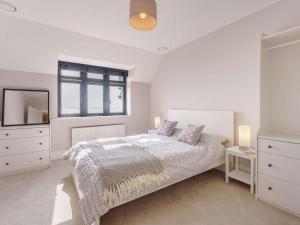 a white bedroom with a bed and a window at 3 Bed in Hythe oc-87167 in Hythe
