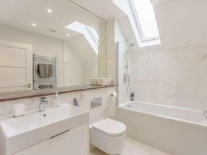 a bathroom with a sink and a toilet and a bath tub at 3 Bed in Hythe oc-87167 in Hythe +16 photos