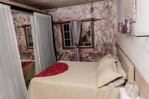 a small bedroom with a bed and a window at Country house, peace comfort & love in Contagem