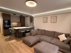 a living room with a couch and a kitchen at Sunny Waves Apartment in Cullera