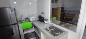 a small kitchen with a counter and a refrigerator at Relax in El Cerrito