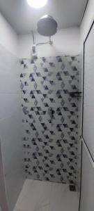 a bathroom with a shower with a tile wall at Relax in El Cerrito