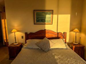 a bedroom with a bed with two lamps on tables at Departamento La Serena Vista al Mar in La Serena