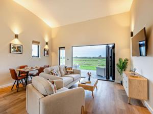 a living room with a couch and a table at 2 Bed in Somerton oc-92126 in Babcary