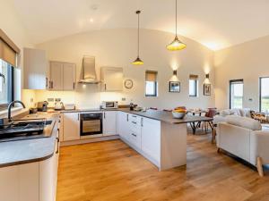a kitchen with white cabinets and a dining room at 2 Bed in Somerton oc-92126 in Babcary +10 photos
