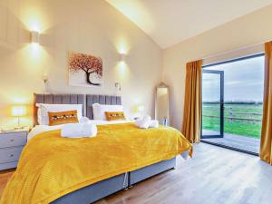 a bedroom with a large bed and a sliding glass door at 2 Bed in Somerton oc-92126 in Babcary