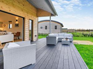 a patio with white wicker furniture on a wooden deck at 2 Bed in Somerton oc-92126 in Babcary