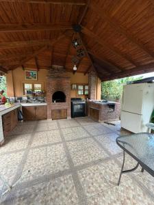 a large kitchen with a stove and a refrigerator at Villa Ana Rosa in Jarabacoa +6 photos