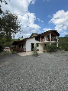 a large white house with a large driveway at Villa Ana Rosa in Jarabacoa