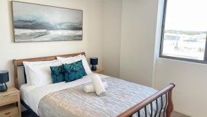 a bedroom with a bed and a window at Banyandah Towers in Maroochydore +134 photos