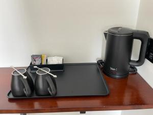a tray with a coffee maker and a coffee pot on a table at Soho Tabuan Kuching in Kuching