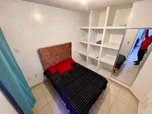 a bedroom with a bed and shelves in a room at casa renta vacacional en mazatlan in Mazatlán +4 photos