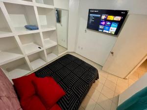 a room with a bed and shelves and a screen at casa renta vacacional en mazatlan in Mazatlán