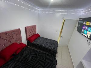 a small room with two beds and a sign at casa renta vacacional en mazatlan in Mazatlán