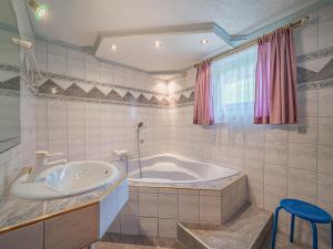 a bathroom with a tub and a sink at Poschen in Wald im Pinzgau +29 photos