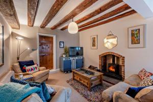 a living room with a couch and a fireplace at 3 Bed in Ruthin oc-a29313 in Ruthin