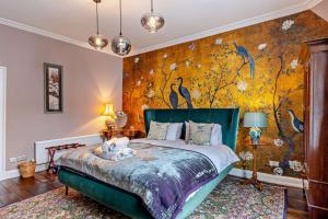 a bedroom with a large bed with a floral wallpaper at 3 Bed in Ruthin oc-a29313 in Ruthin