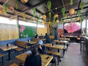 a restaurant with wooden tables and people sitting at tables at Hotel Escalada in Oaxaca City