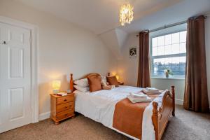 a bedroom with a bed and a large window at 3 Bed in Llanbedr oc-t28932 in Llanbedr