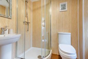 a bathroom with a shower and a toilet and a sink at 3 Bed in Llanbedr oc-t28932 in Llanbedr +22 photos