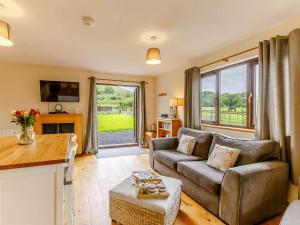 a living room with a couch and a table at 2 Bed in Llandrindod Wells oc-88203 in Llandegley