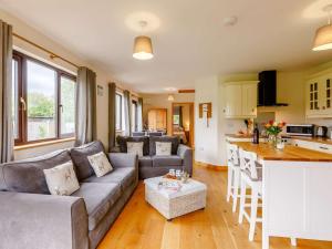a living room with a couch and a kitchen at 2 Bed in Llandrindod Wells oc-88203 in Llandegley +21 photos