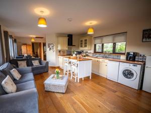 a kitchen and living room with a couch and a table at 2 Bed in Llandrindod Wells oc-88203 in Llandegley