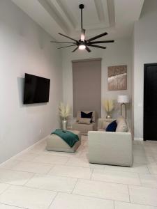 a living room with two couches and a ceiling fan at Rabbit Run Home in Alton