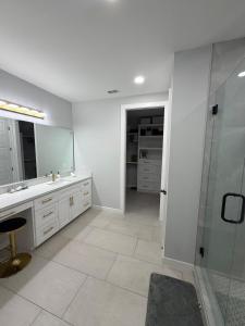 a bathroom with a shower and a sink and a mirror at Rabbit Run Home in Alton