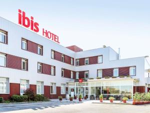 a hotel with a red and white building at Ibis Irun in Irún