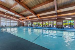 a large indoor swimming pool with a wooden ceiling at Stoneridge Resort in Blanchard