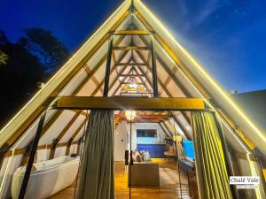 a boat inside of a triangular building with curtains at Chalés Exclusivos com Jacuzzi em Bonito Mato Grosso do Sul in Bonito