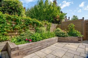 a garden with a wooden fence and flowers at 4 Bed in Aldeburgh oc-16faw in Aldeburgh