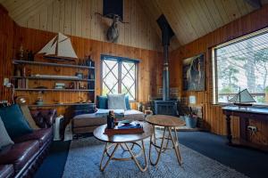 a living room with a couch and a table at Cygnet Cabin in Lymington