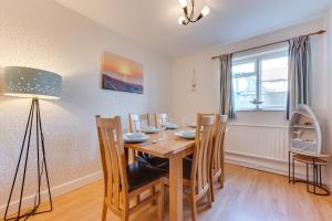 a dining room with a wooden table and chairs at 4 Bed in Southwold oc-ivy in Southwold