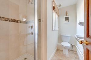 a bathroom with a shower and a toilet and a sink at 4 Bed in Southwold oc-ivy in Southwold