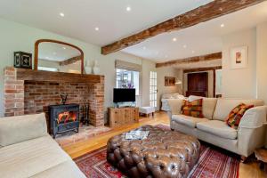 a living room with a couch and a fireplace at 3 Bed in Snape oc-g29478 in Snape