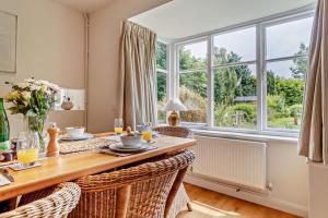 a dining room with a table and a large window at 3 Bed in Snape oc-g29478 in Snape