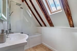 a bathroom with a white sink and a skylight at 3 Bed in Snape oc-g29478 in Snape +17 photos