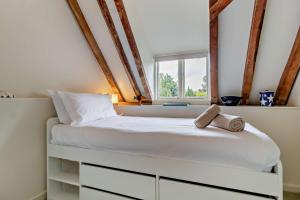 a bedroom with a white bed with a window at 3 Bed in Snape oc-g29478 in Snape