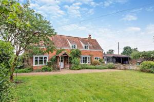 a brick house with a yard in front of it at 3 Bed in Snape oc-g29478 in Snape