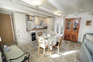 a living room with a table and a kitchen at 3 Bed in Swansea oc-hh405 in Llanmadoc