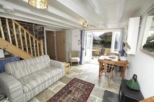 a living room with a couch and a table at 3 Bed in Swansea oc-hh405 in Llanmadoc