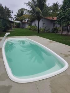 a large swimming pool in a yard with a house at Mangut in São Miguel dos Milagres